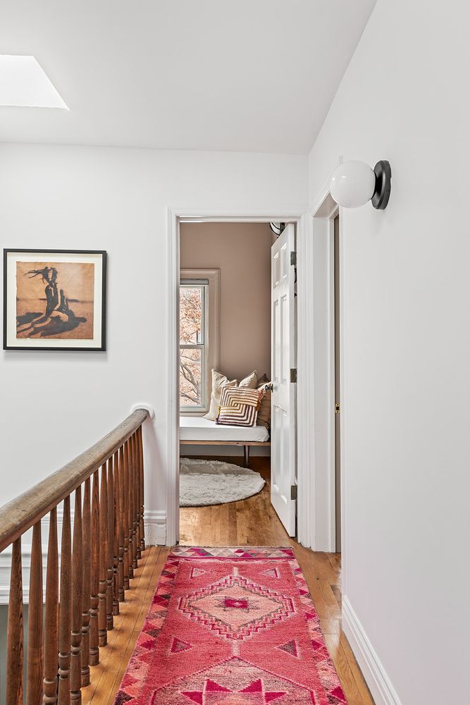 a bedroom with a bed and a rug