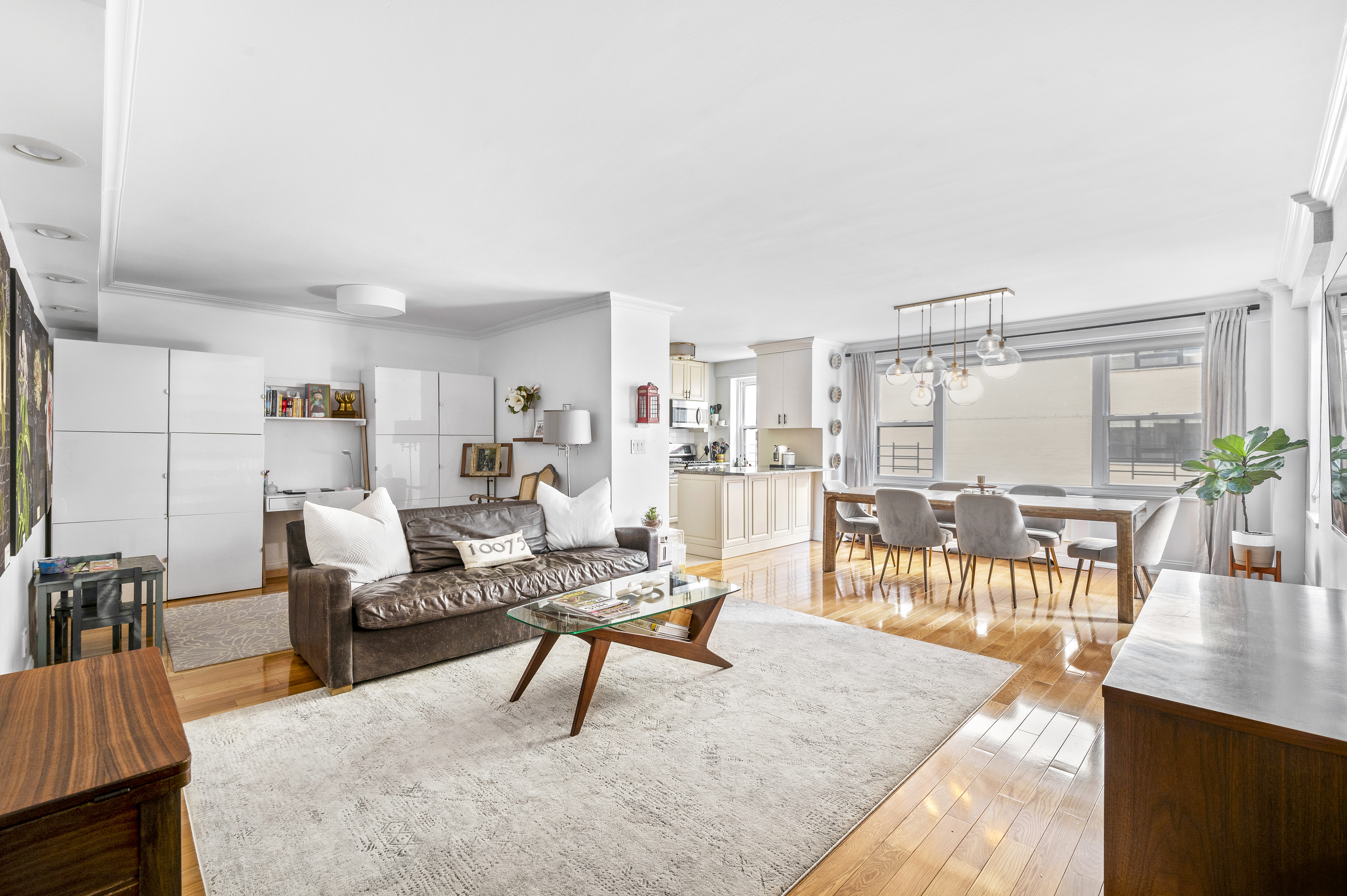 201 East 79th Street, Unit 6A Manhattan, NY 10075 - Photo 3 of 11 a living room with furniture and view of kitchen