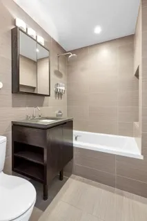 a bathroom with a sink a toilet and a mirror
