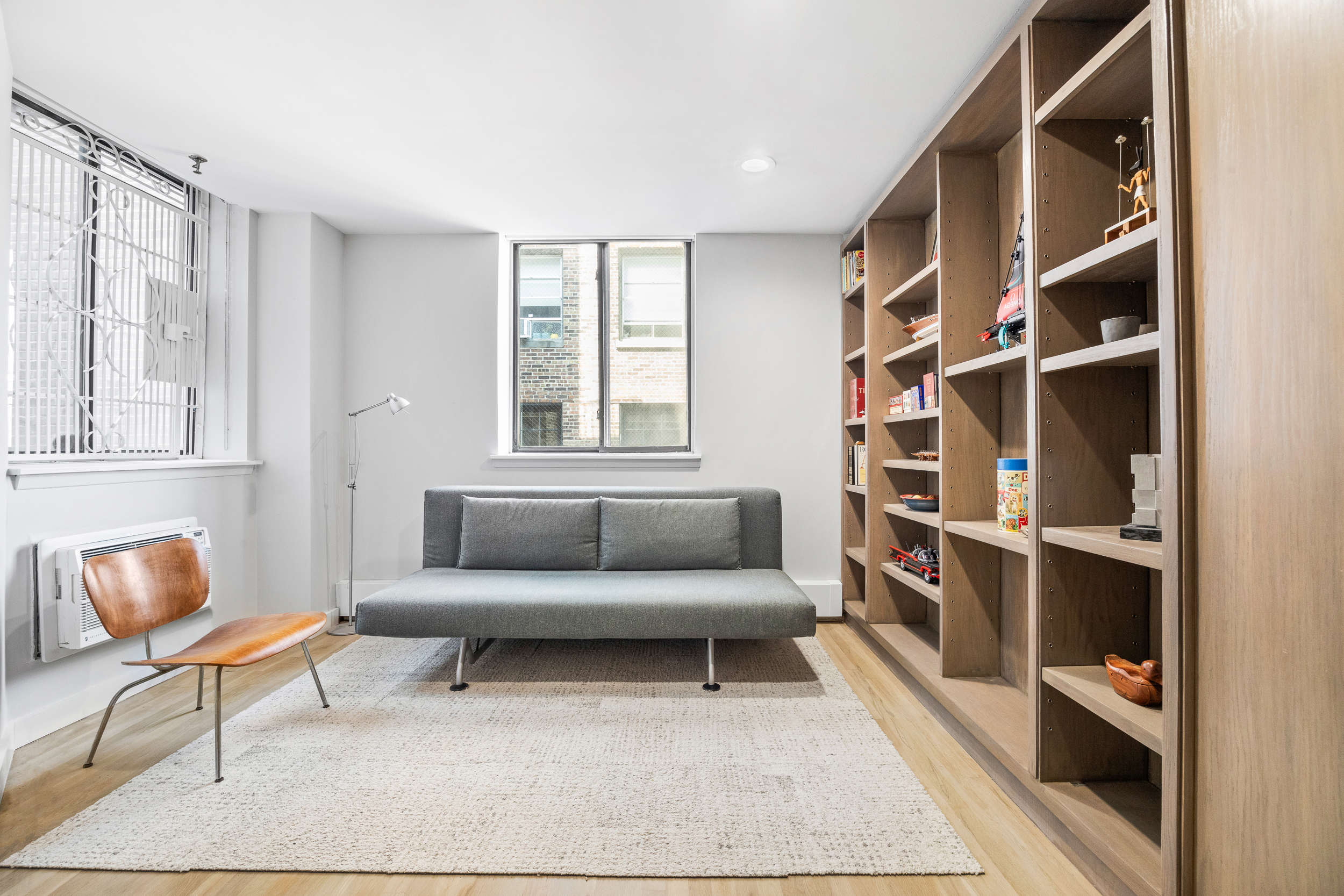 330 West End Avenue, Unit PHB Manhattan, NY 10023 - Photo 14 of 20 a living room with furniture and a book shelf