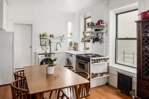 a kitchen with a table and chairs in it