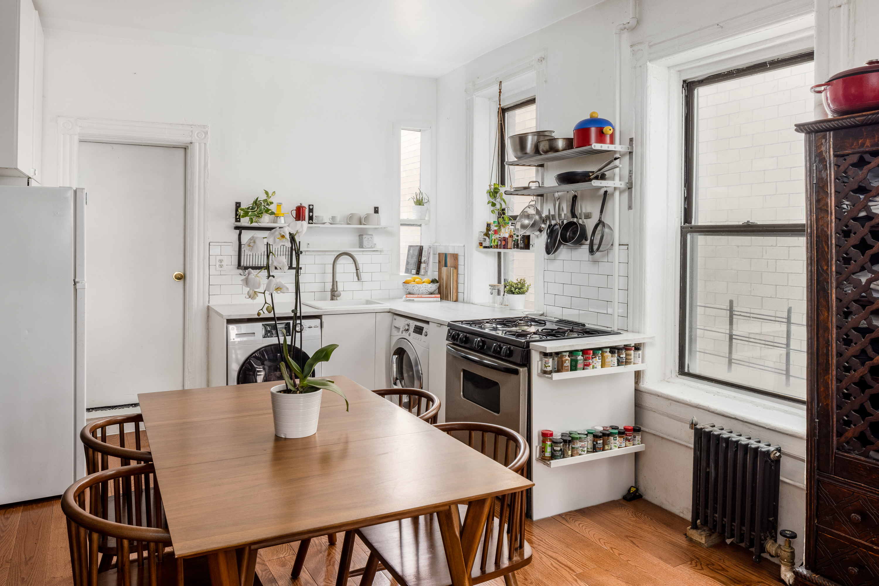 327 East 3rd Street, Unit 4B Manhattan, NY 10009 - Photo 3 of 9 a kitchen with a table and chairs in it