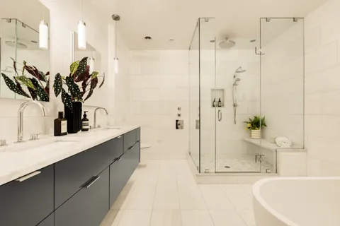 a bathroom with a tub sink and mirror