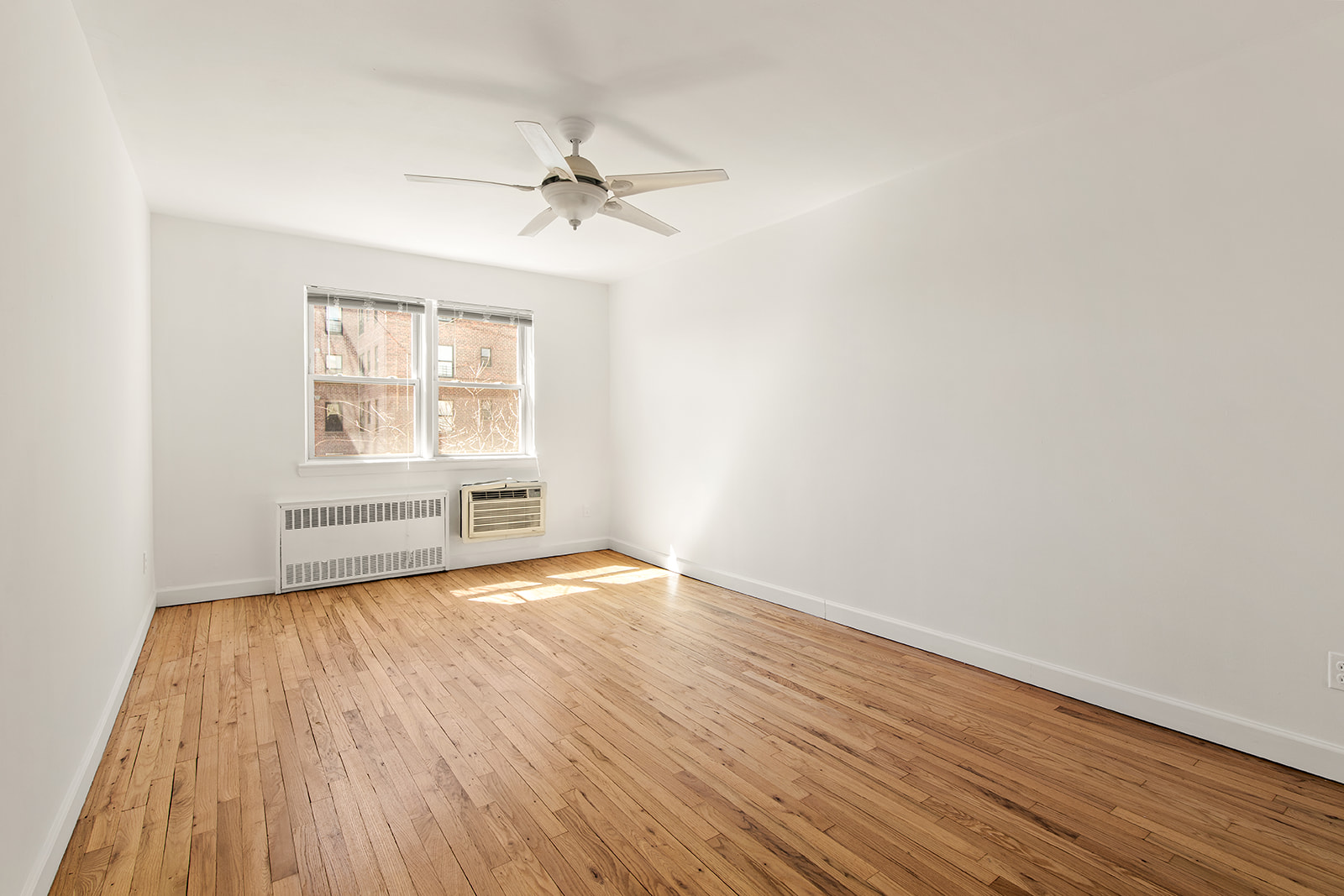 572 92nd Street Brooklyn, NY 11209 - Photo 18 of 20 wooden floor in an empty room with a window