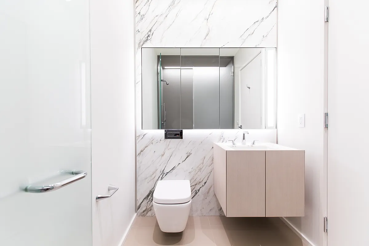 121 East 22nd Street, Unit N205 Manhattan, NY 10010 - Photo 4 of 17 a bathroom with a sink a toilet and shower