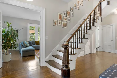 a view of entryway and hall with wooden floor