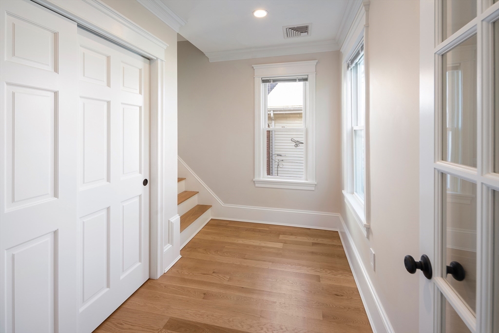 48-50 Amsden Street, Unit 2 Arlington, MA 02474 - Photo 12 of 34 a view of an entryway with wooden floor and door