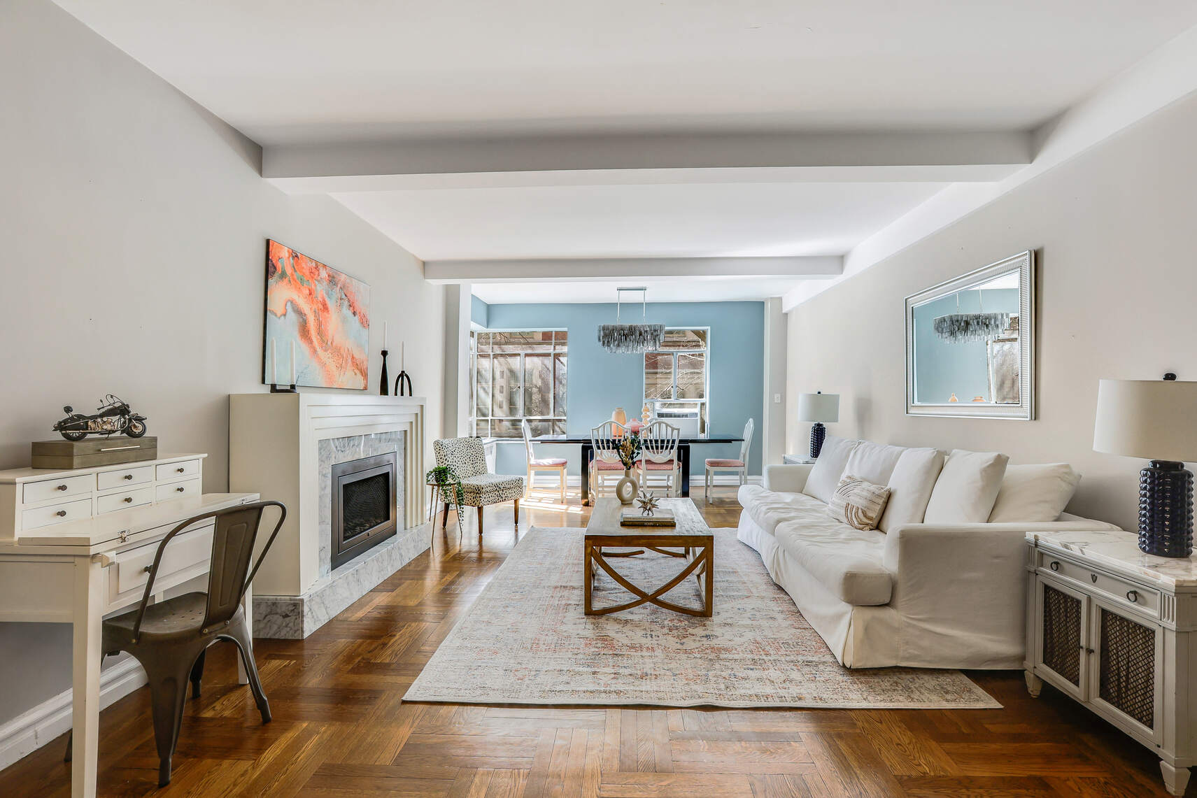565 West End Avenue, Unit 3C Manhattan, NY 10024 - Photo 4 of 15 a living room with furniture a fireplace and a table