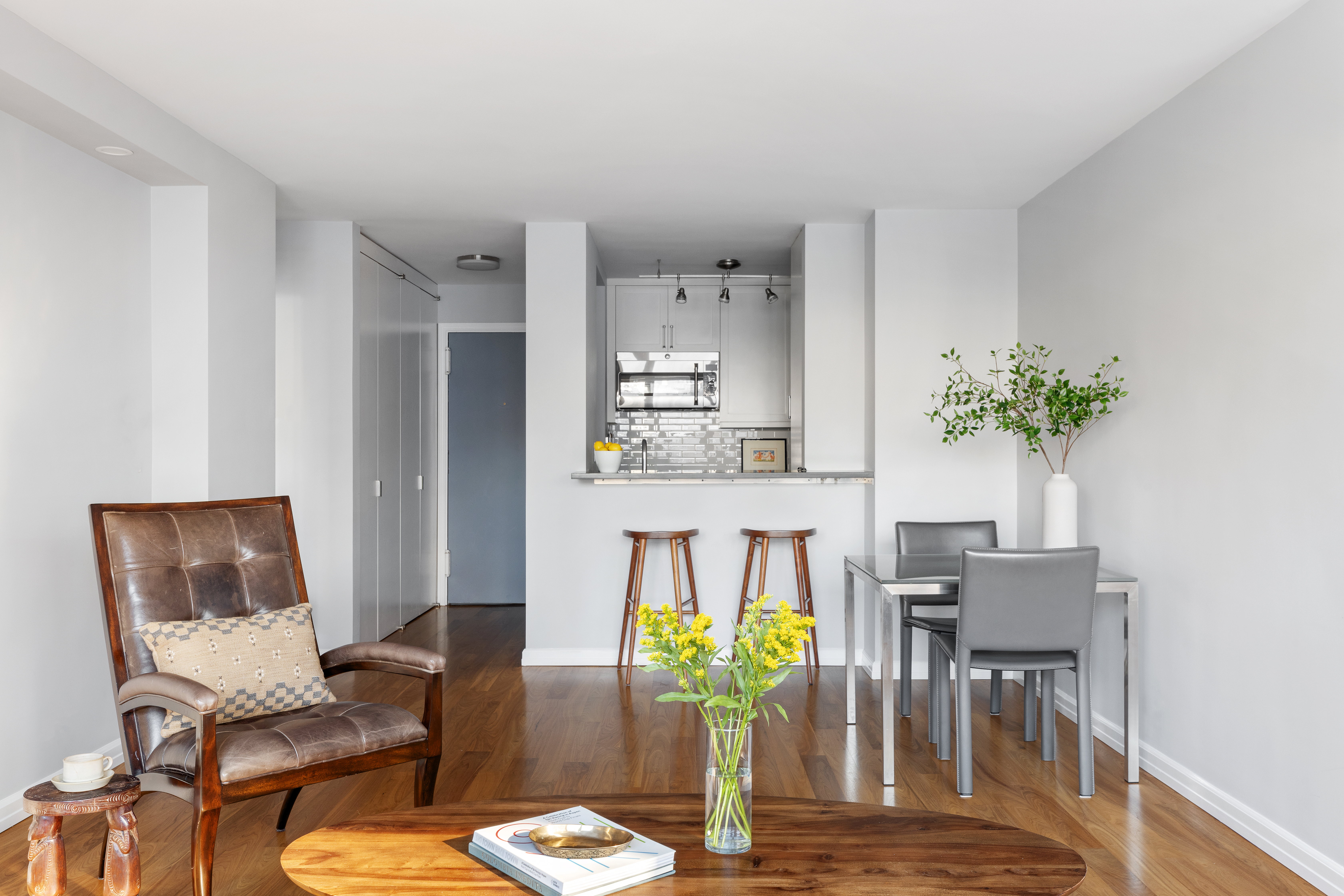 225 East 57th Street, Unit 9M Manhattan, NY 10022 - Photo 4 of 10 a view of a dining room with furniture and wooden floor