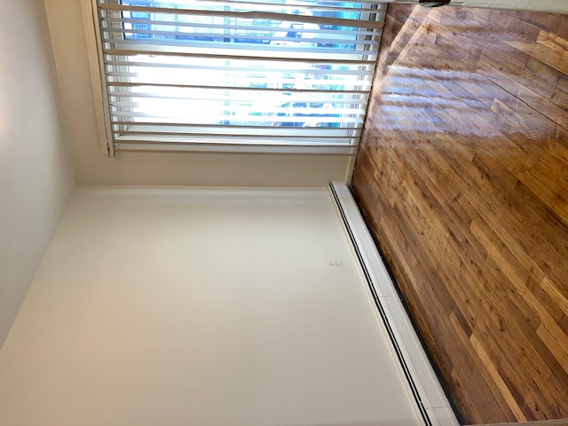 1653 West 9th Street, Unit 2 Brooklyn, NY 11223 - Photo 3 of 7 a view of an empty room with wooden floor and a window
