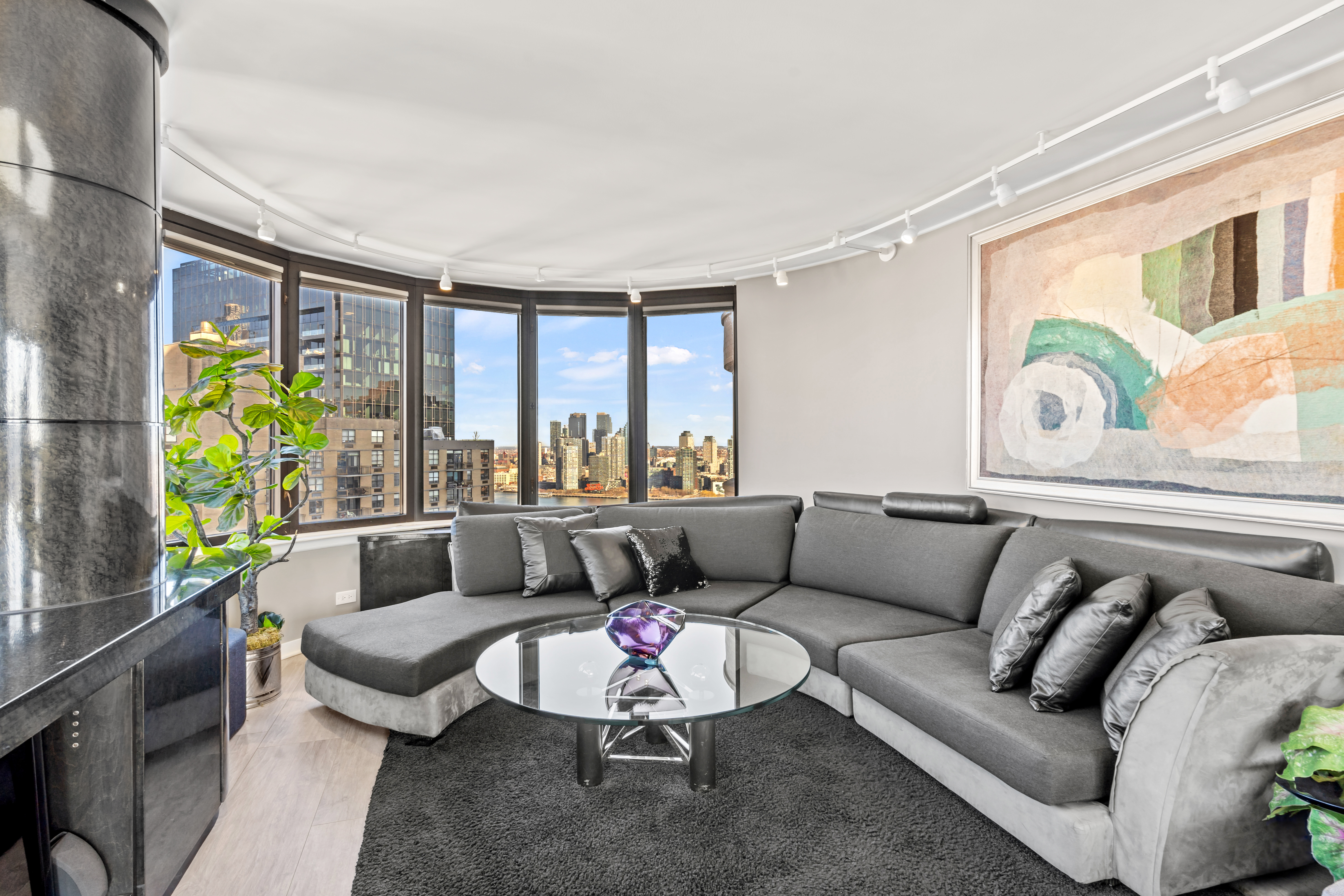 330 East 38th Street, Unit 38E Manhattan, NY 10016 - Photo 5 of 35 a living room with furniture and a large window
