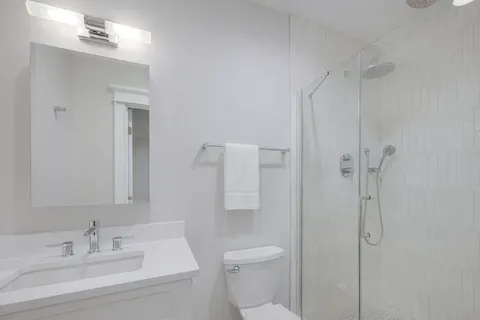 a bathroom with a sink toilet and shower