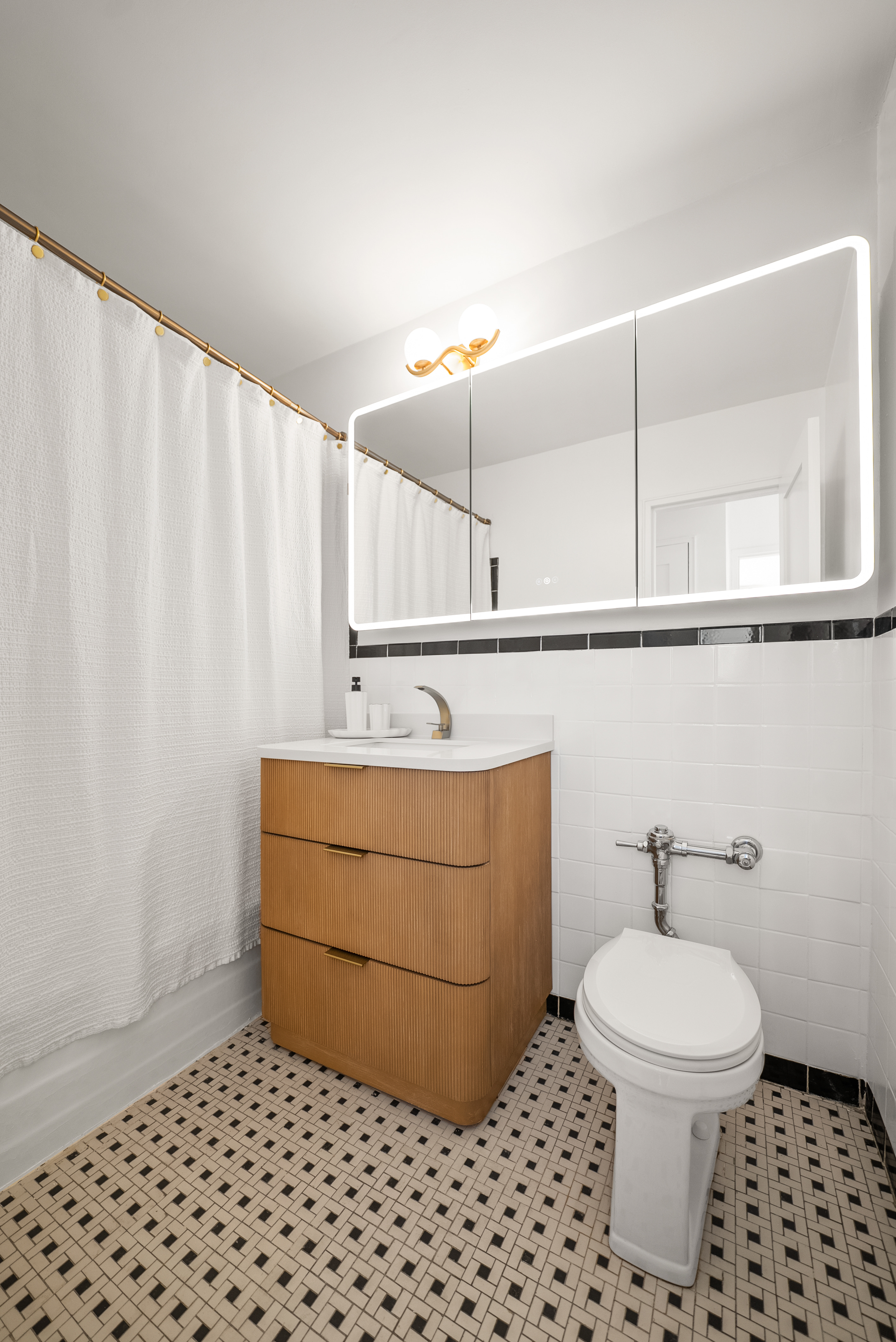 165 Christopher Street, Unit 6DD Manhattan, NY 10014 - Photo 7 of 8 a bathroom with a sink a toilet and a mirror