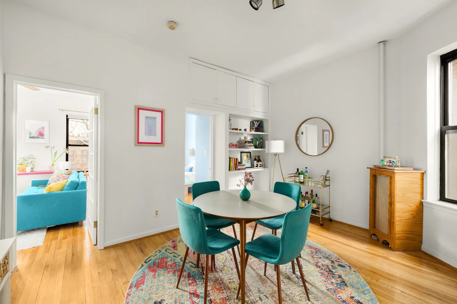 a view of a dining room with furniture and wooden floor