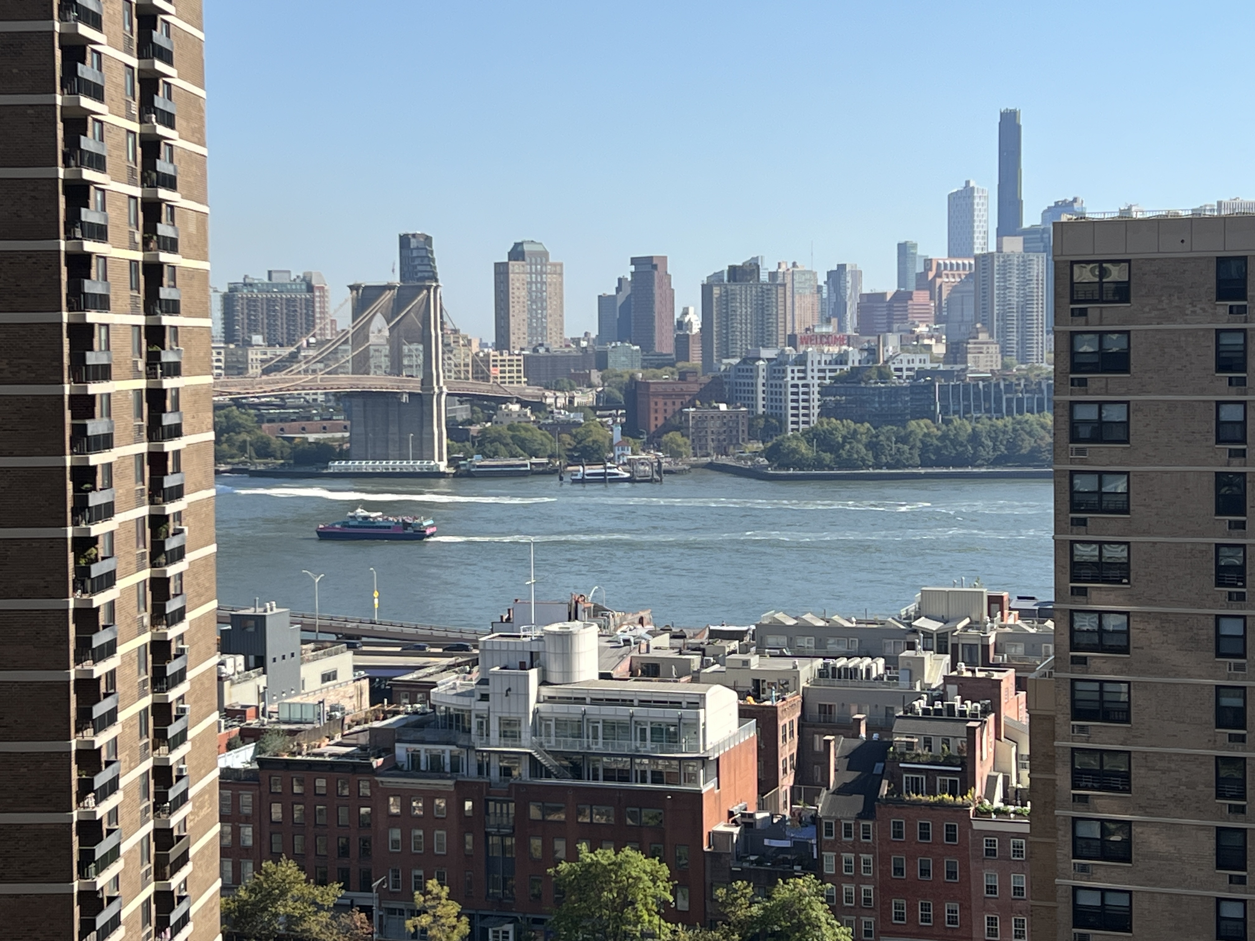 a city view with tall buildings and a lake view