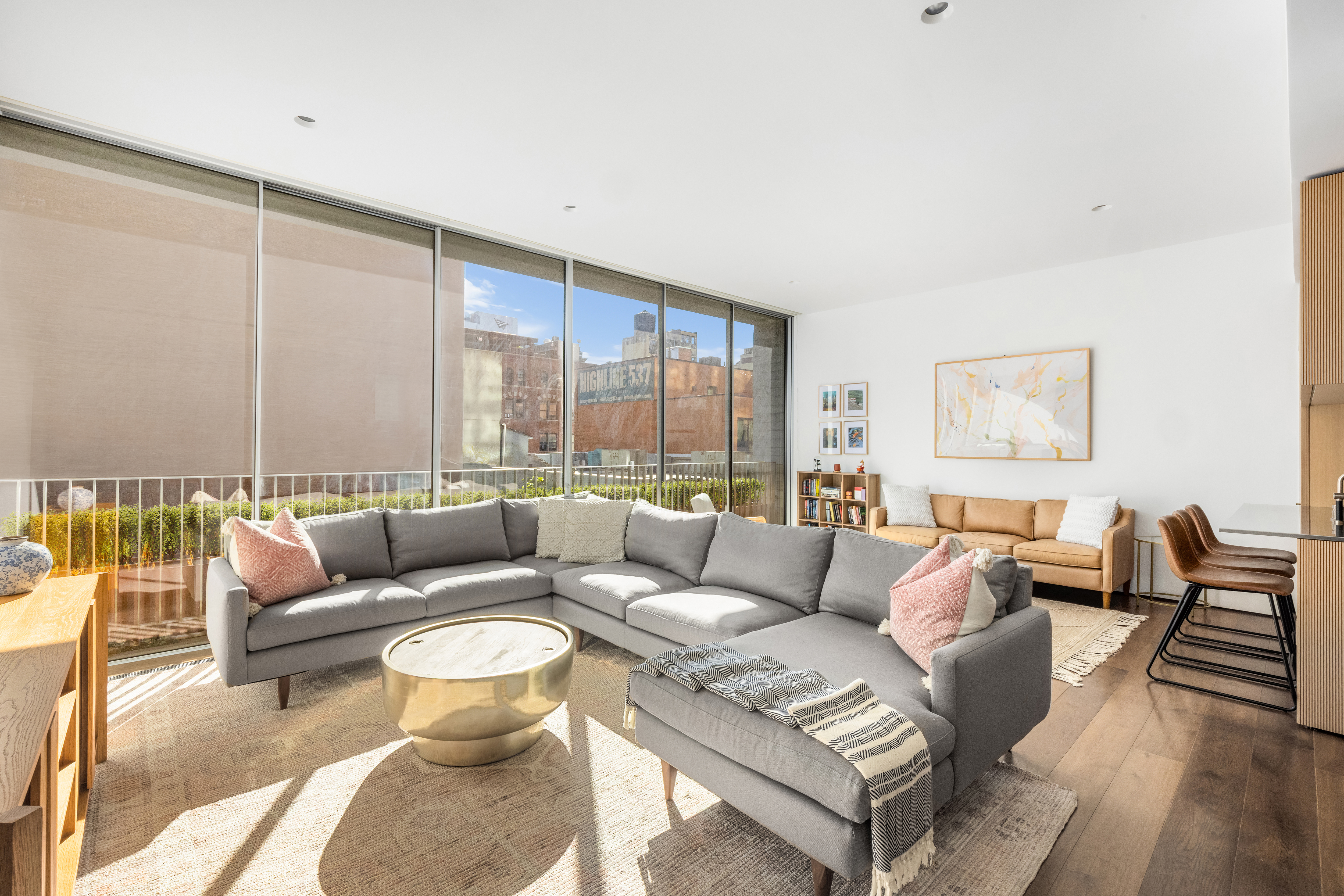 527 West 27th Street, Unit 4C Manhattan, NY 10001 - Photo 1 of 25 a living room with furniture and a large window