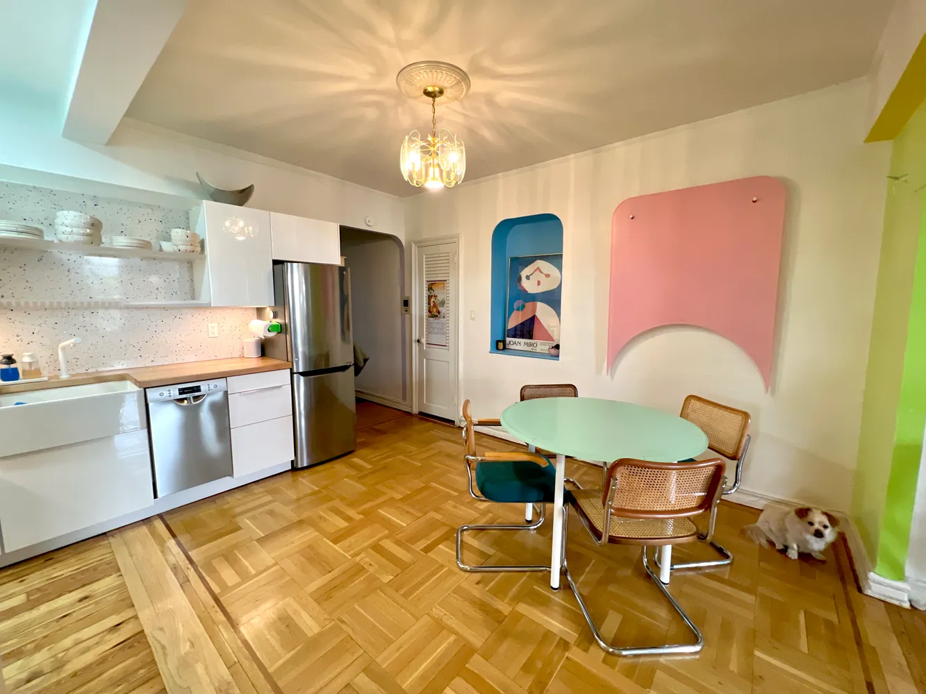 a view of a dining room with furniture and a chandelier