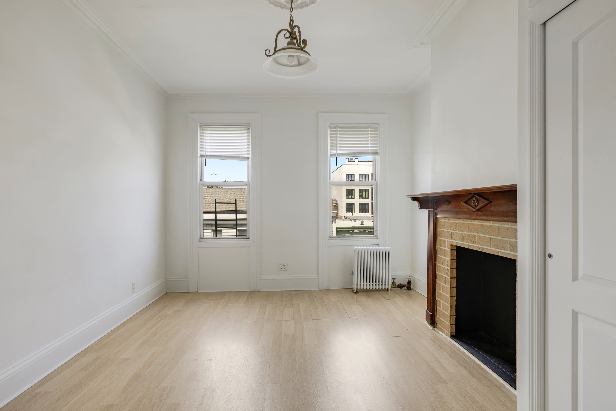100 Powers Street, Unit 3L Brooklyn, NY 11211 - Photo 4 of 17 an empty room with windows and fireplace
