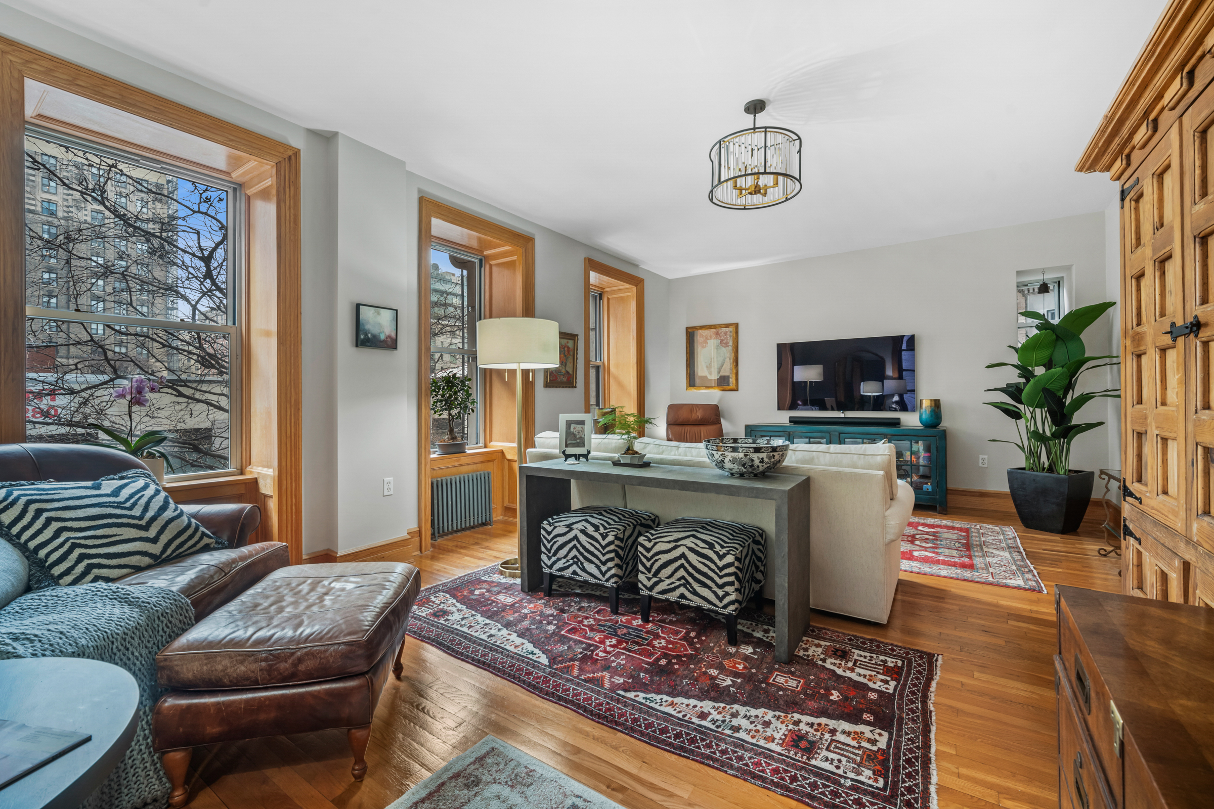 300 West 109th Street, Unit 2JK Manhattan, NY 10025 - Photo 3 of 18 a living room with furniture a rug and a flat screen tv