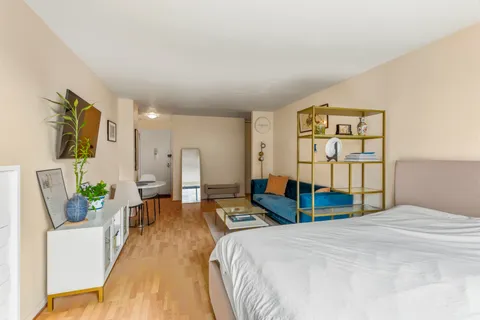 a bedroom with a bed window and couch