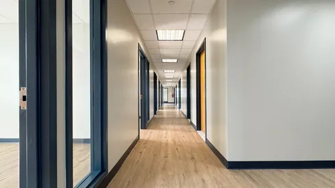 a view of hallway with wooden floor