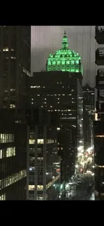 a living room with furniture a chandelier and a painting on the wall