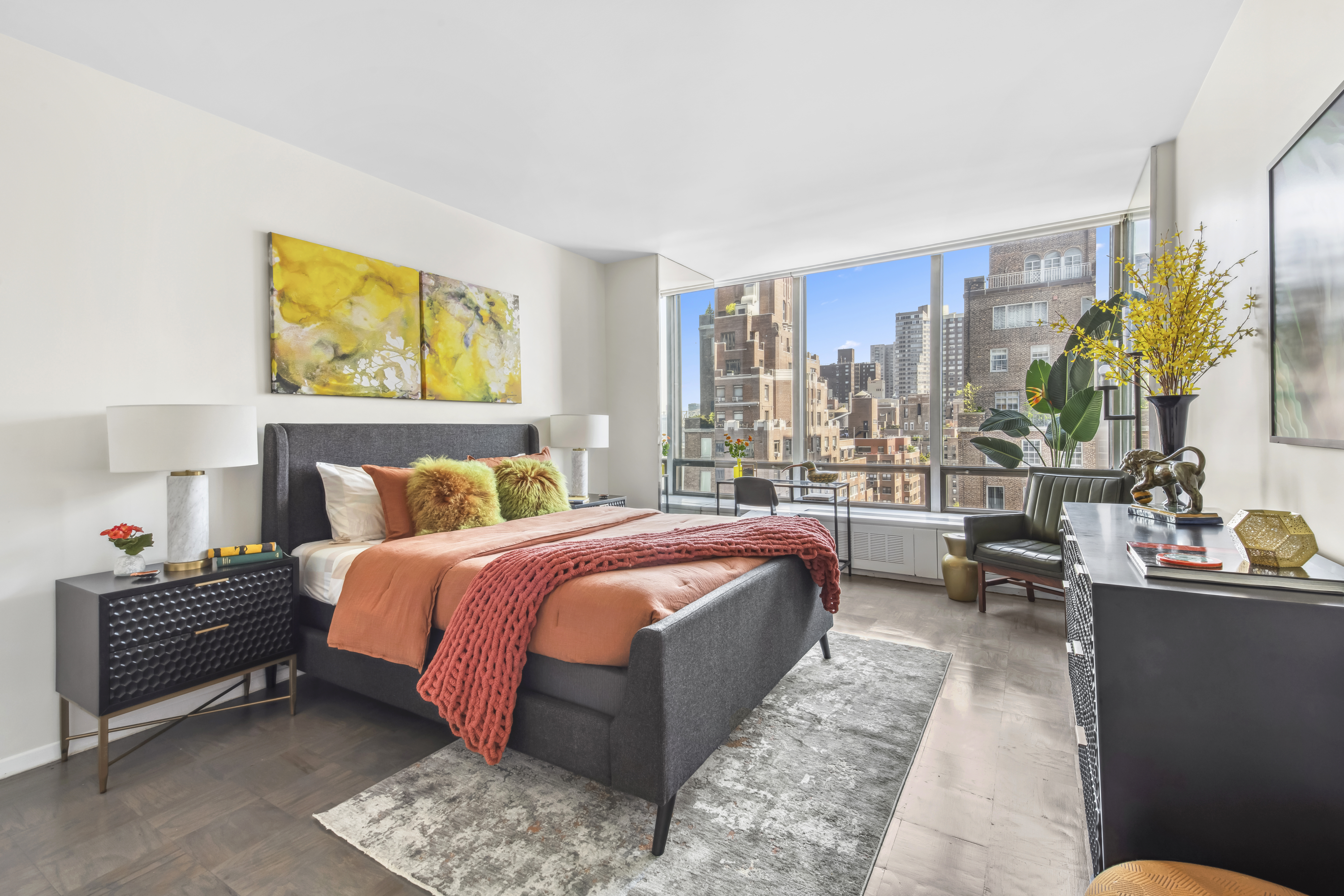 870 United Nations Plaza, Unit 15E Manhattan, NY 10017 - Photo 10 of 19 a bedroom with a bed lamps and window