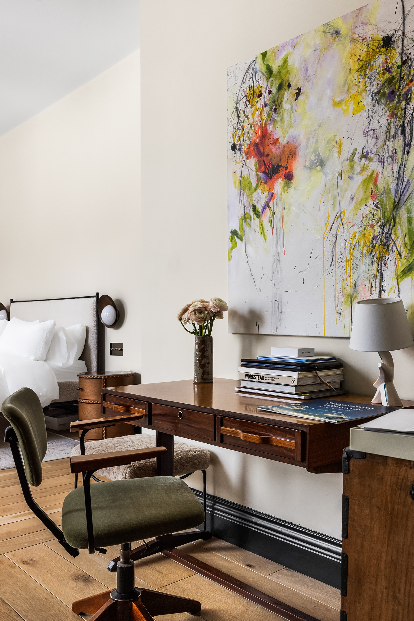 158 Mercer Street, Unit 6B Manhattan, NY 10012 - Photo 10 of 16 a table with a vase and flowers on it