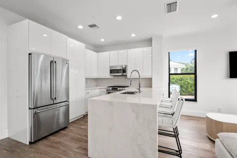a living room with a bed furniture and a flat screen tv