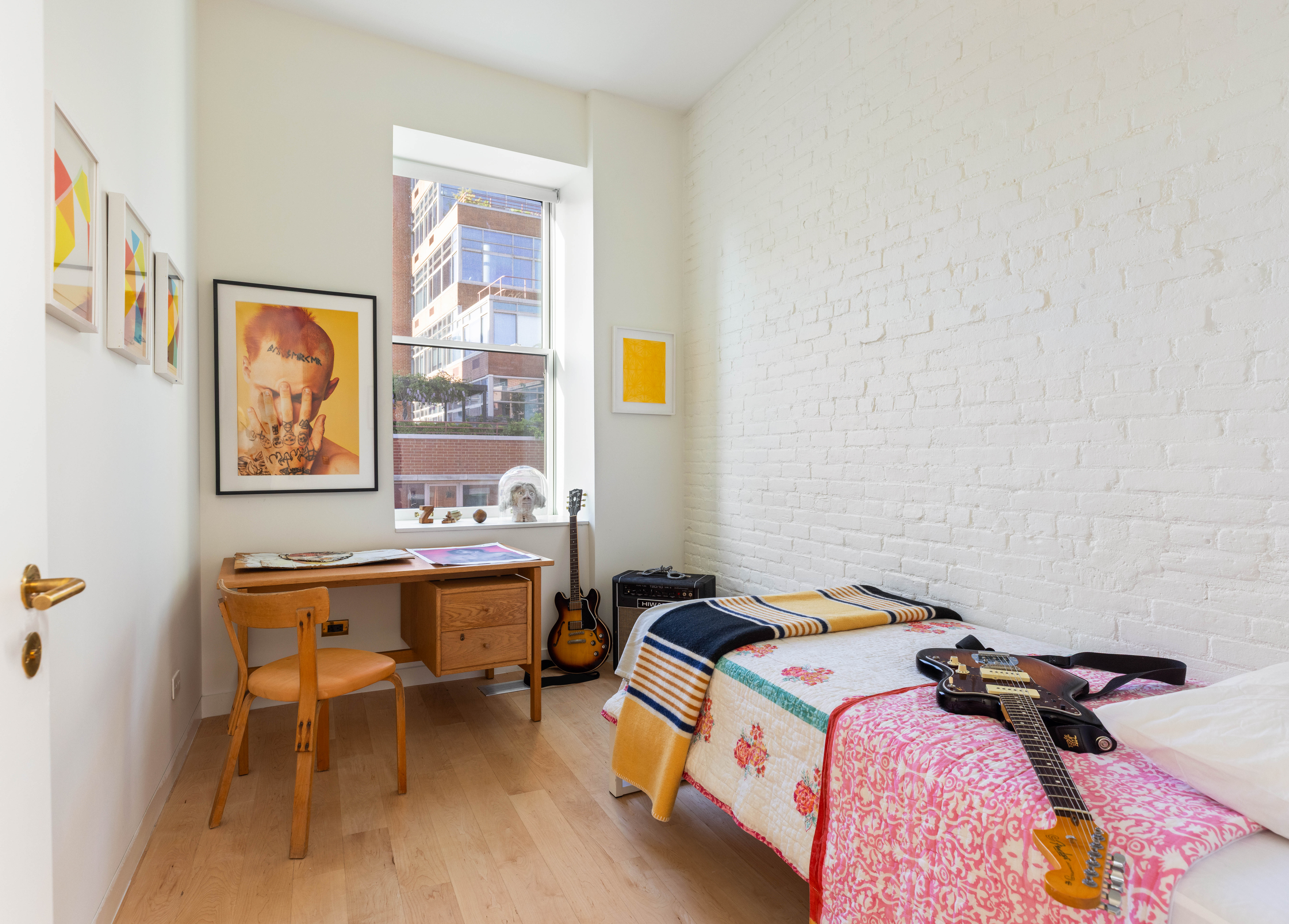 130 Jane Street, Unit 5/6F Manhattan, NY 10014 - Photo 17 of 23 a bedroom with a bed and a table in it