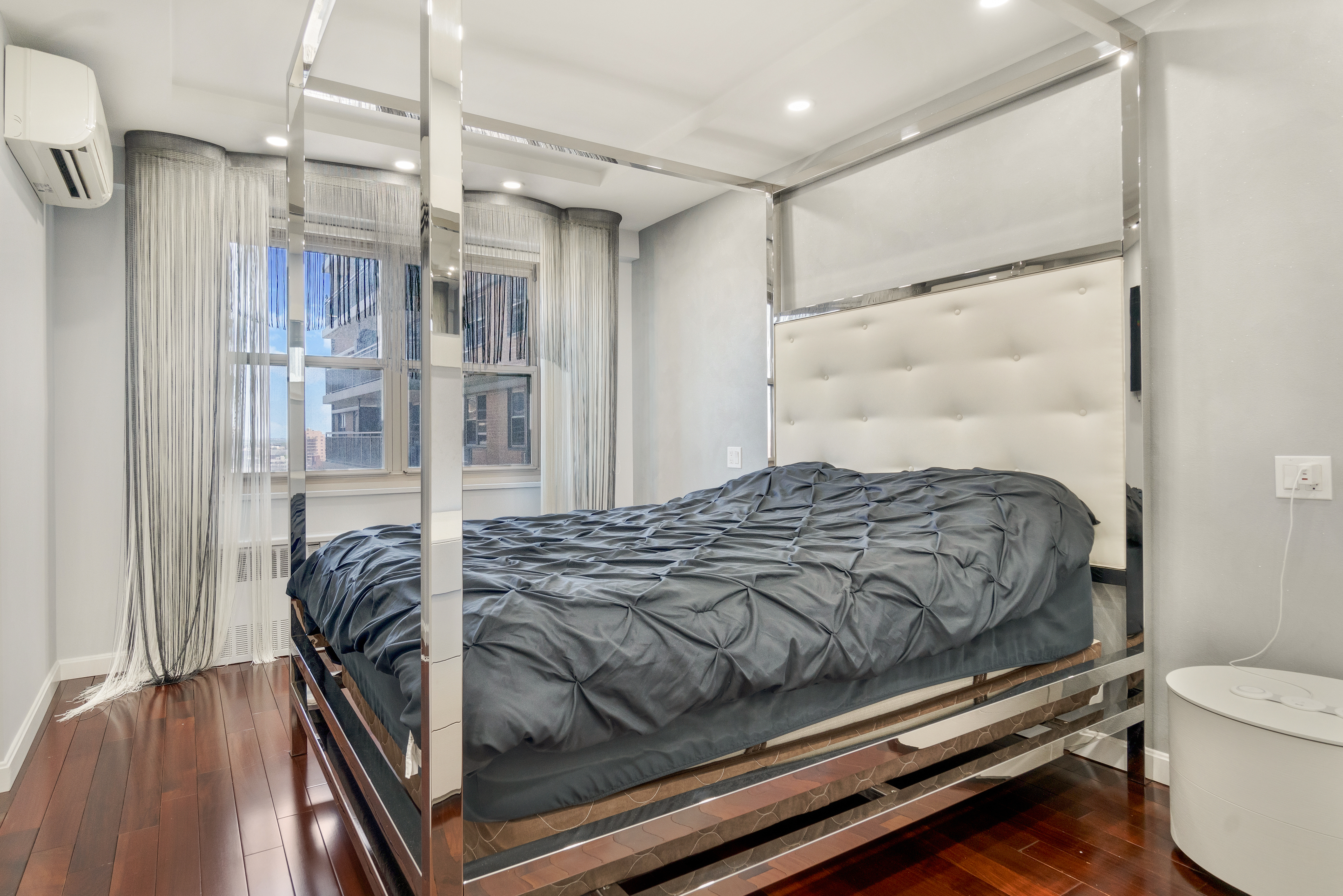 448 Neptune Avenue, Unit 14L Brooklyn, NY 11224 - Photo 10 of 20 a bedroom with a bed and a table with wooden floor