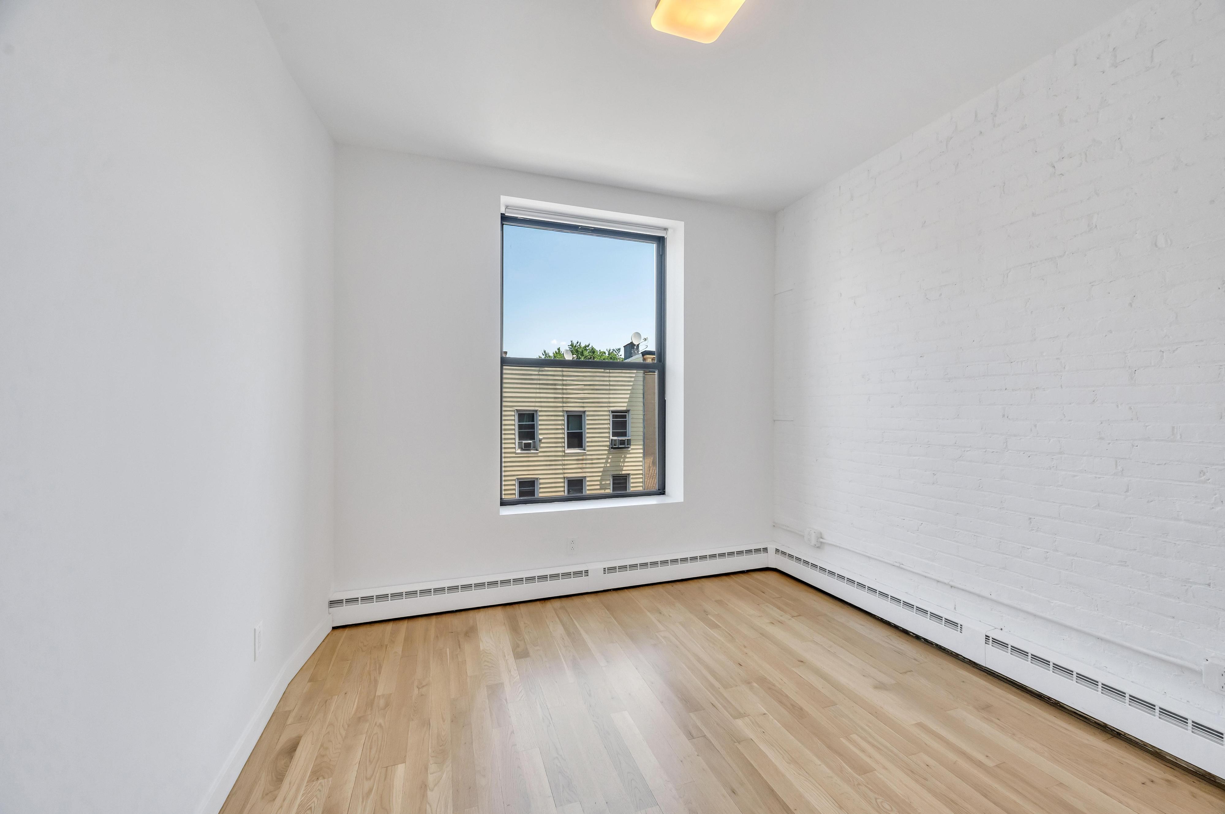 717 Manhattan Avenue, Unit 3A Brooklyn, NY 11222 - Photo 11 of 18 an empty room with a window