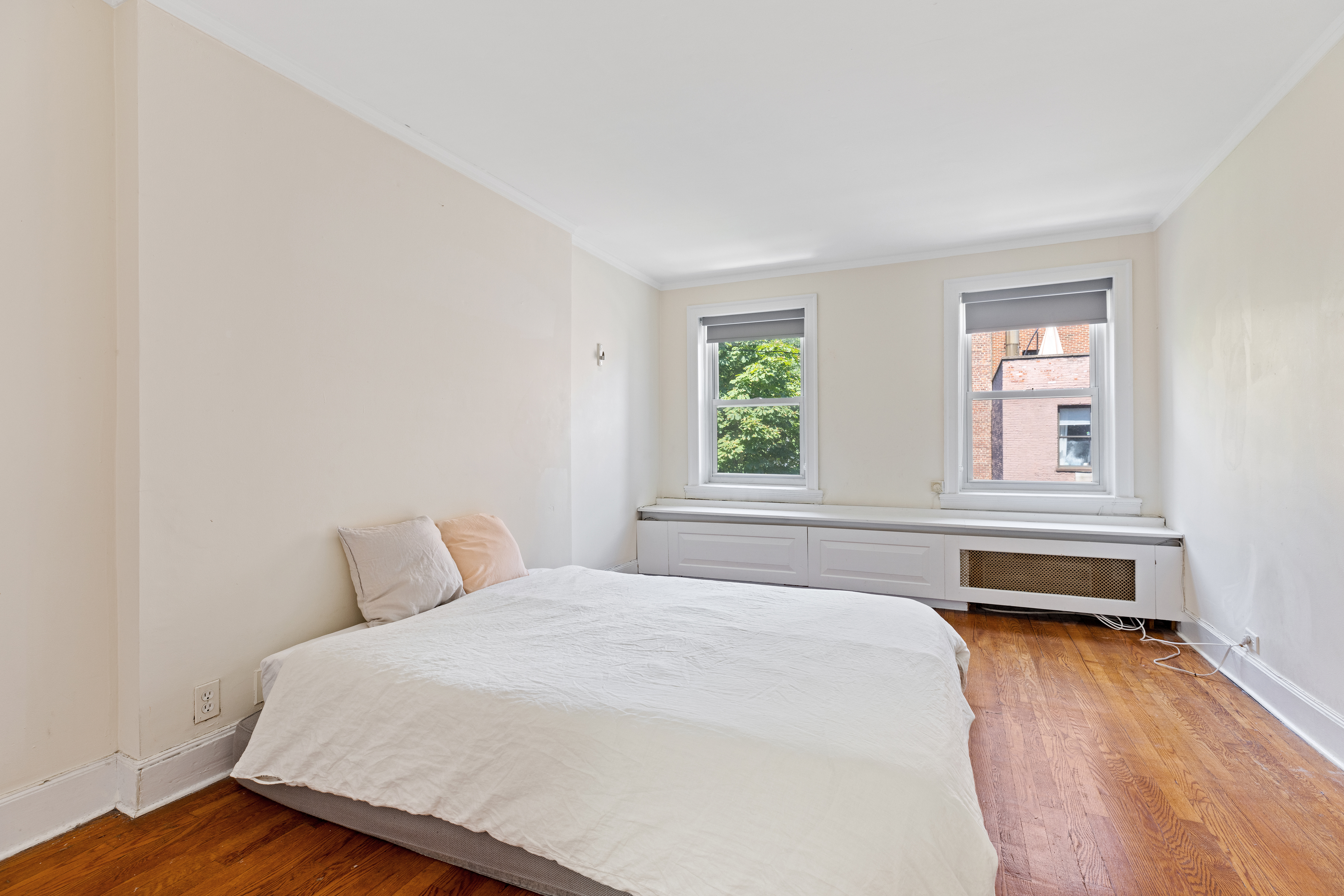 151 East 29th Street, Unit 2 Manhattan, NY 10016 - Photo 7 of 11 a bedroom with a bed and a window
