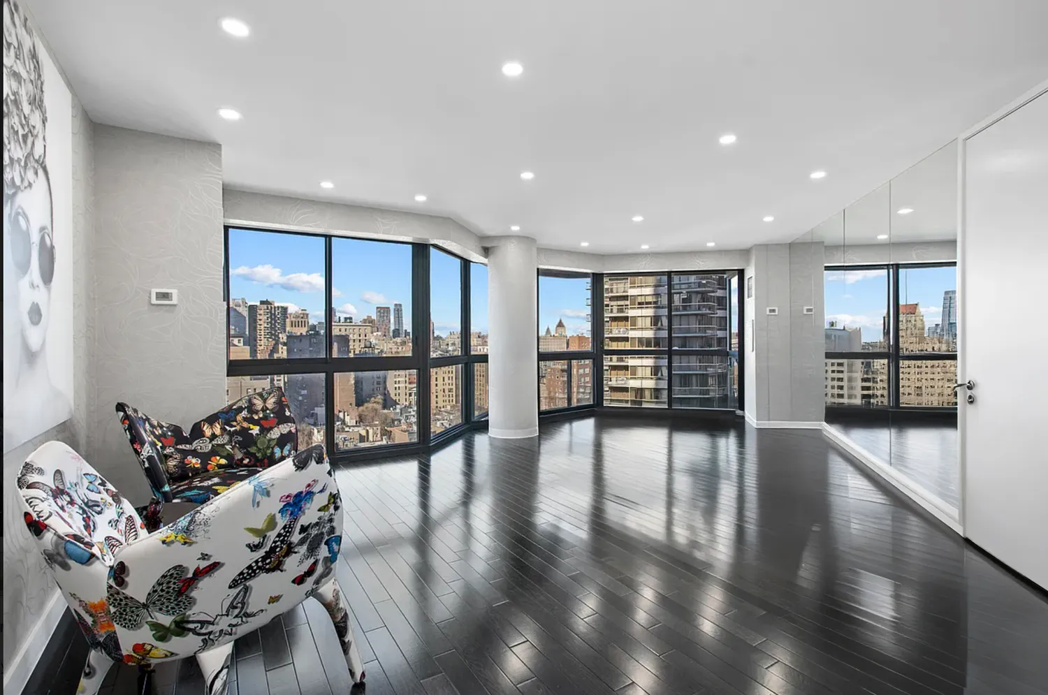 a living room with furniture and large windows