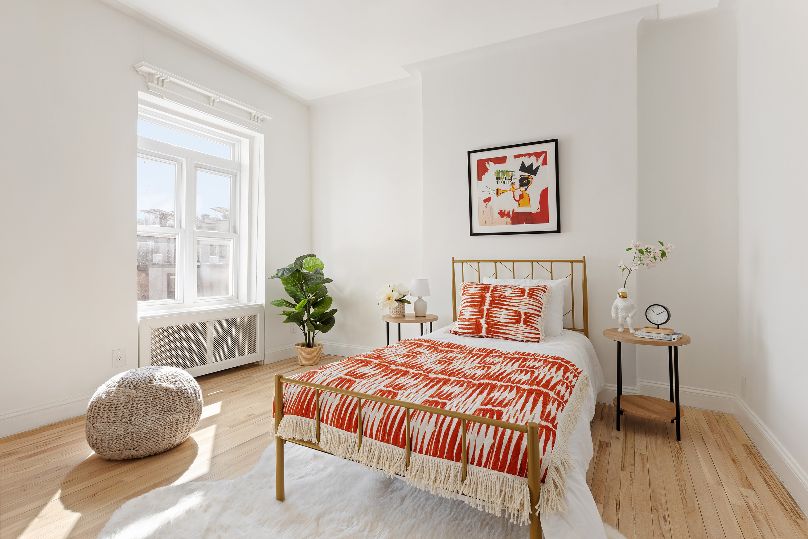 259 New York Avenue Brooklyn, NY 11216 - Photo 19 of 25 a bedroom with a bed and a table