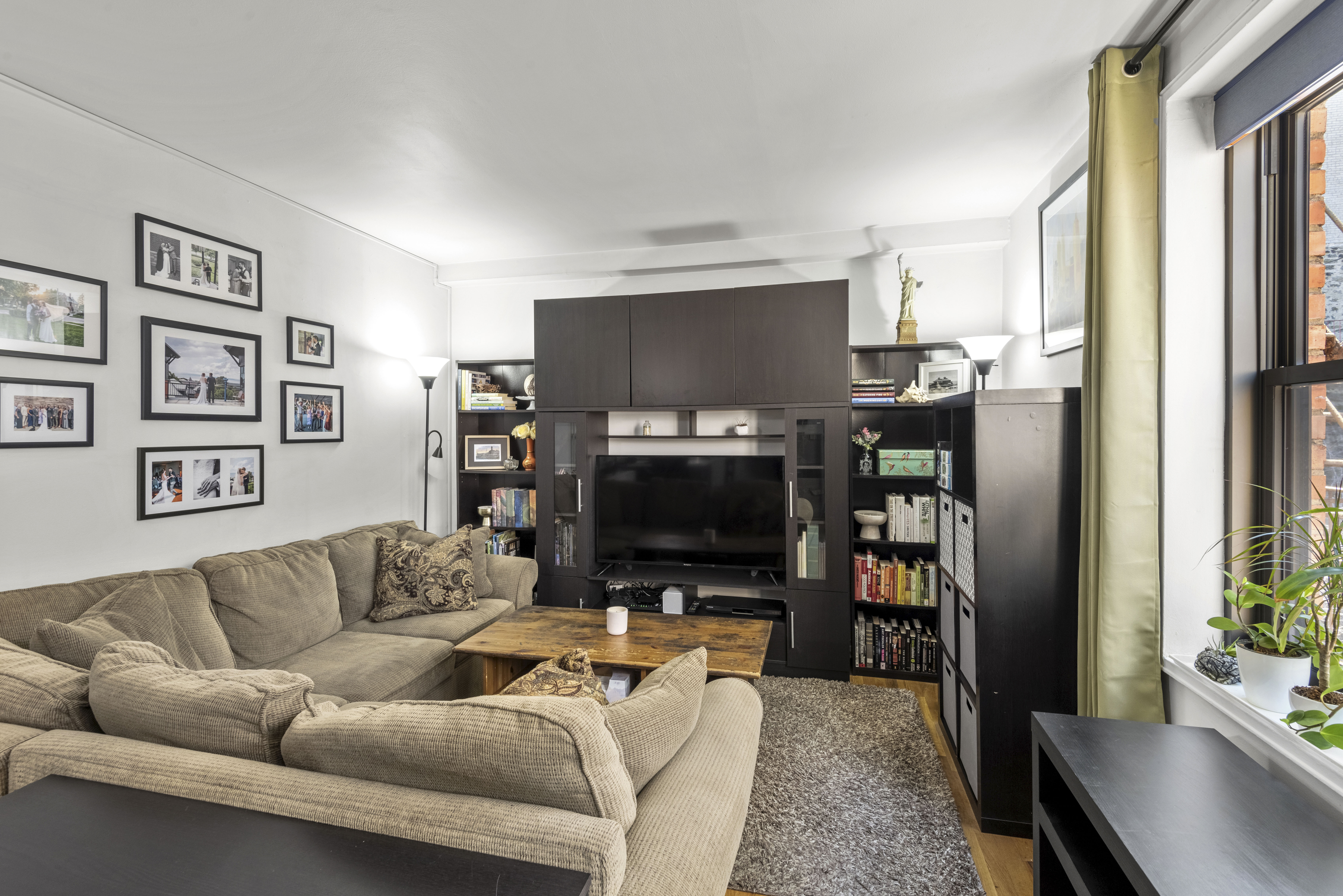 45 Overlook Terrace, Unit 7J Manhattan, NY 10033 - Photo 3 of 11 a living room with furniture and a flat screen tv