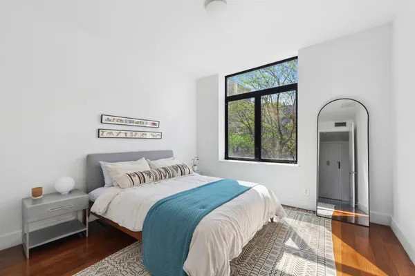 a bedroom with a bed and a window