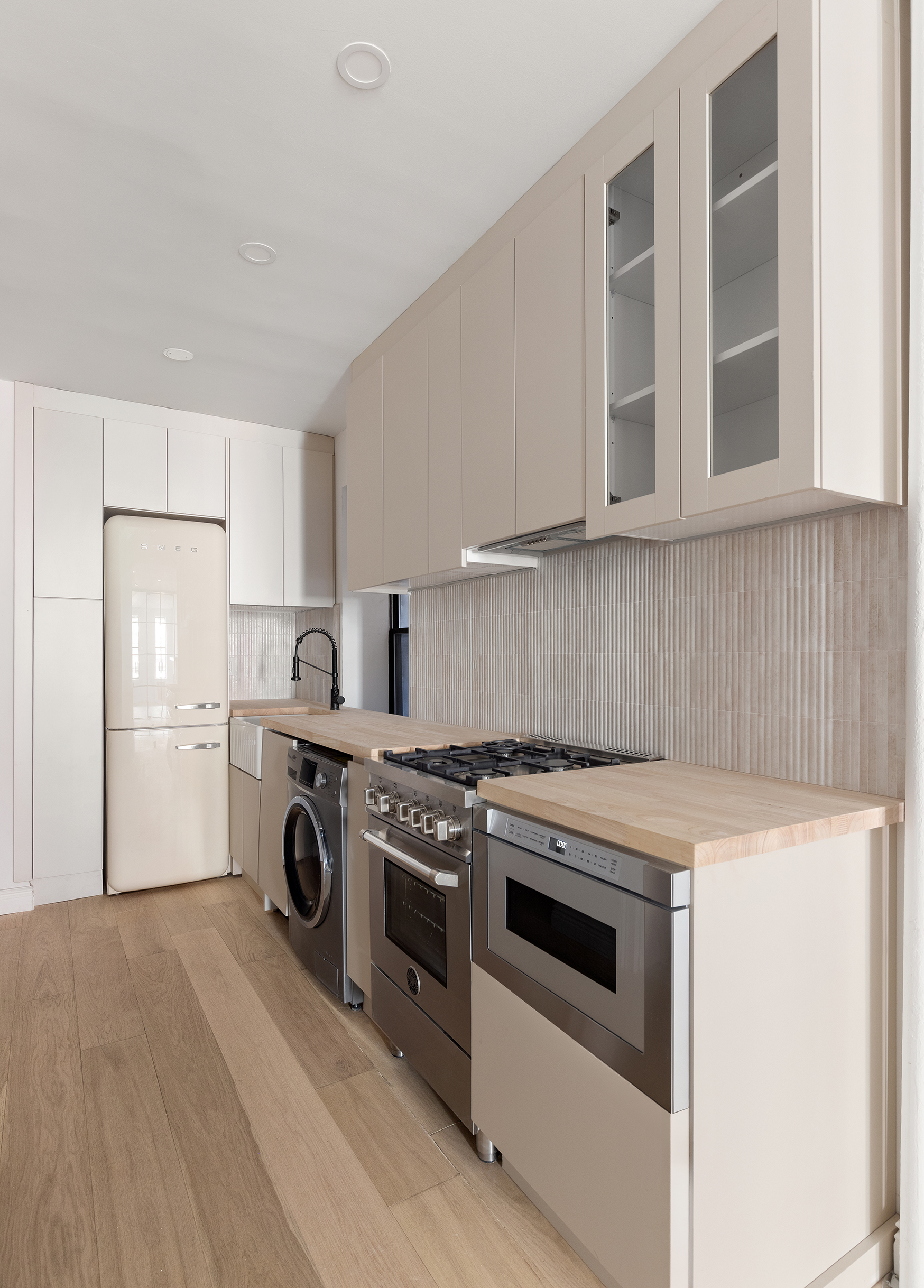 228 West 16th Street, Unit 4B Manhattan, NY 10011 - Photo 3 of 9 a kitchen with a stove top oven and cabinets