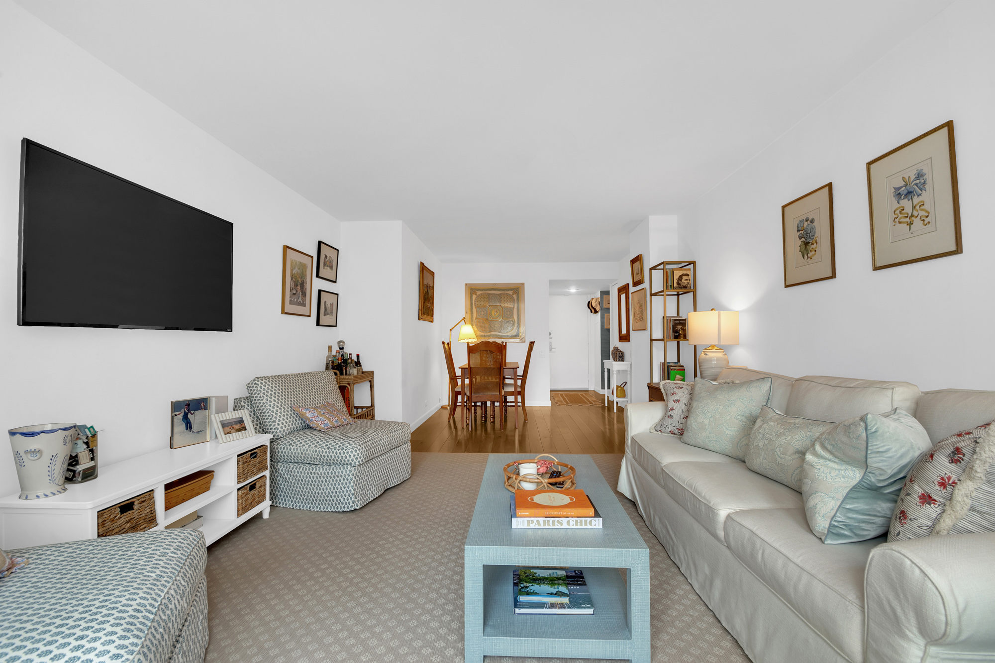 275 Greenwich Street, Unit 11J Manhattan, NY 10007 - Photo 2 of 9 a living room with furniture and a flat screen tv