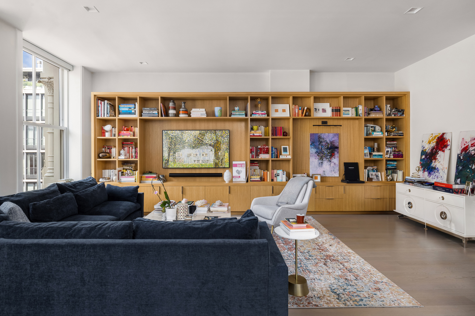 74 Grand Street, Unit 5 Manhattan, NY 10013 - Photo 2 of 12 a living room with furniture and a flat screen tv