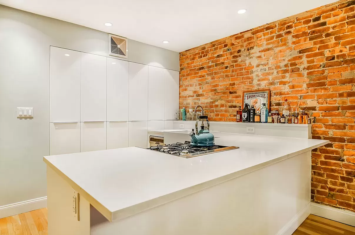 146 Berkeley Place Brooklyn, NY 11217 - Photo 16 of 21 a kitchen with a sink a stove and a refrigerator