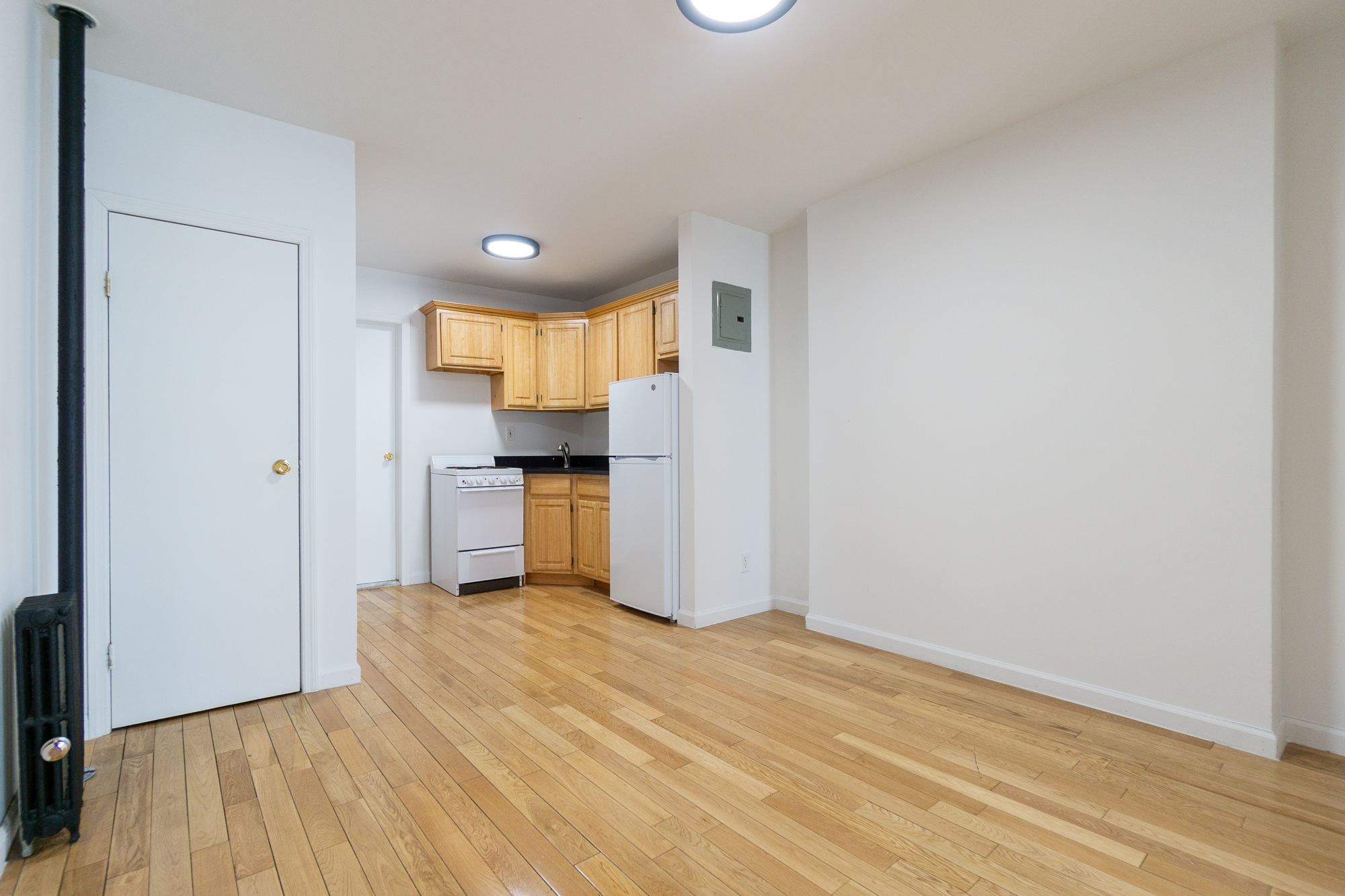 337 East 6th Street, Unit 9 Manhattan, NY 10003 - Photo 8 of 15 a view of a kitchen with a sink and a refrigerator