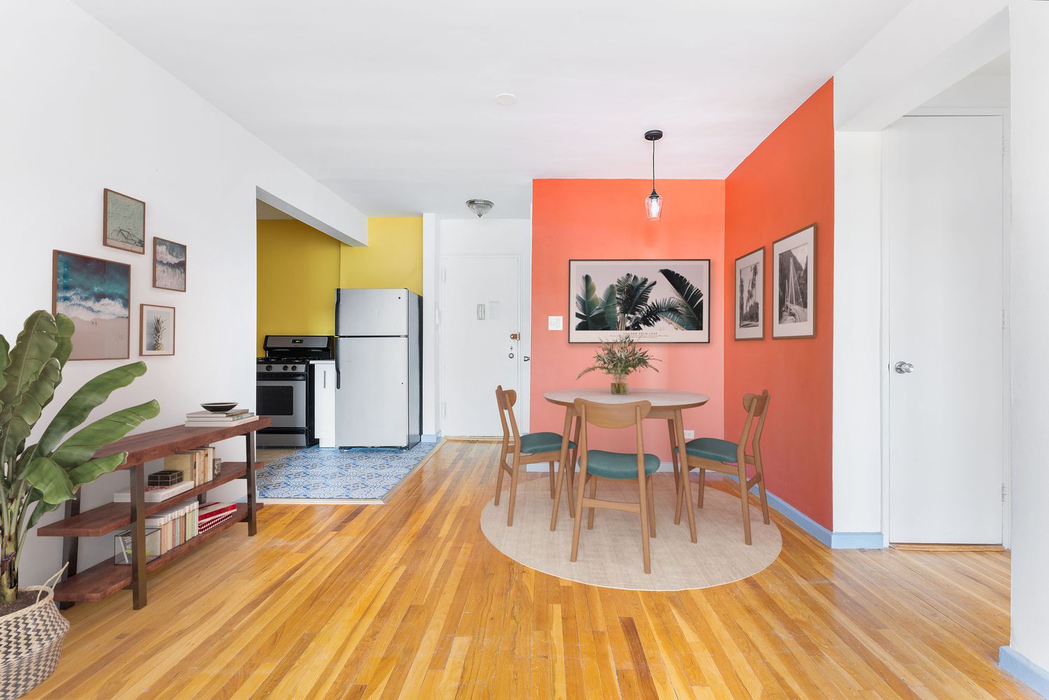 a dining room with furniture and wooden floor