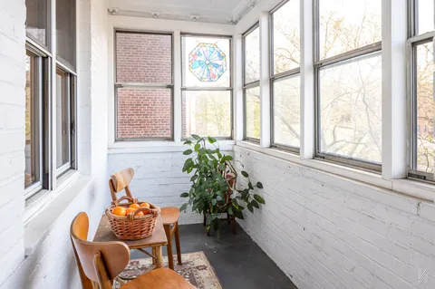a outdoor dining room with furniture and a window