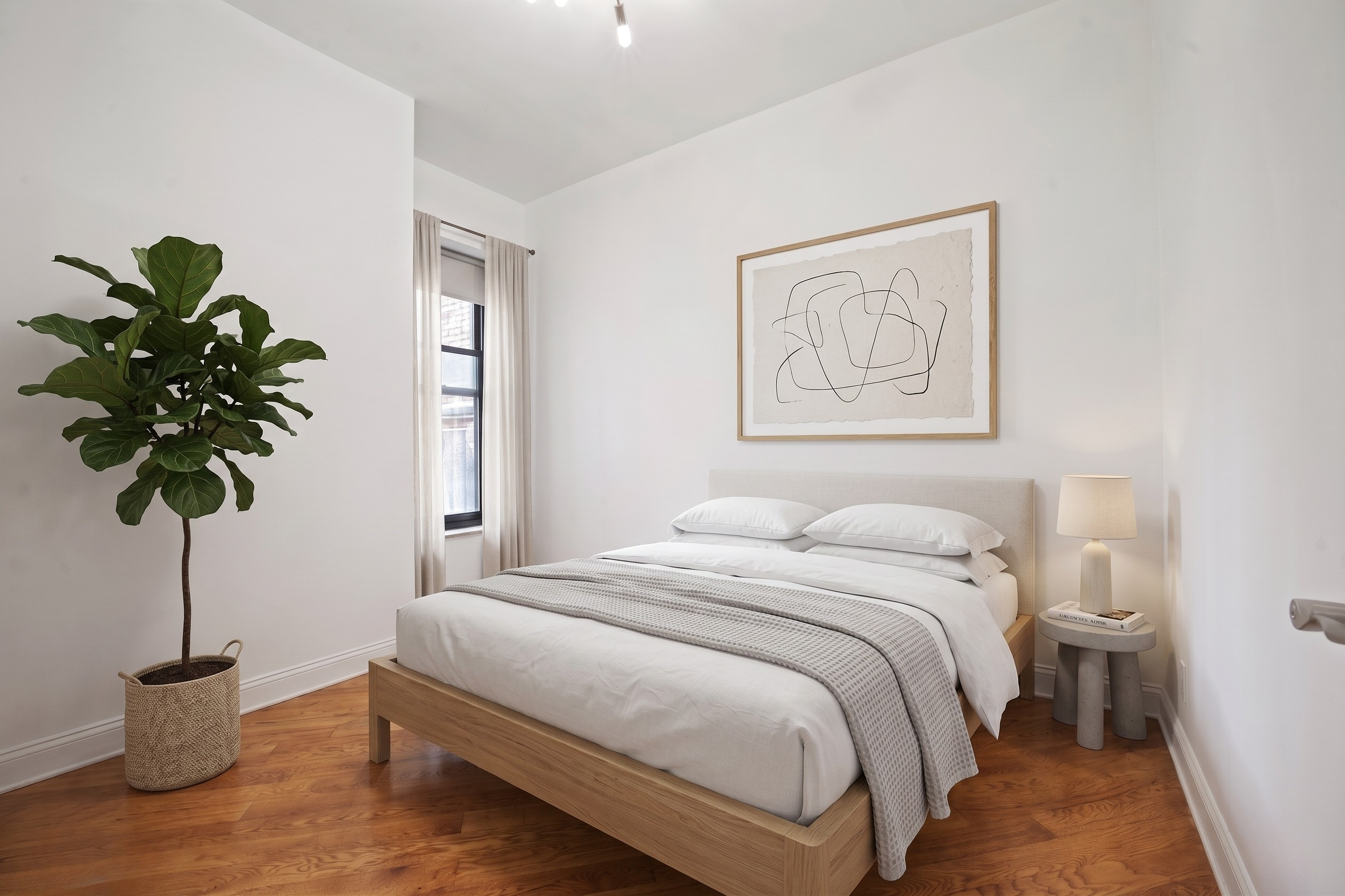 36 West 35th Street, Unit 2A Manhattan, NY 10001 - Photo 8 of 11 a bedroom with a bed and a potted plant
