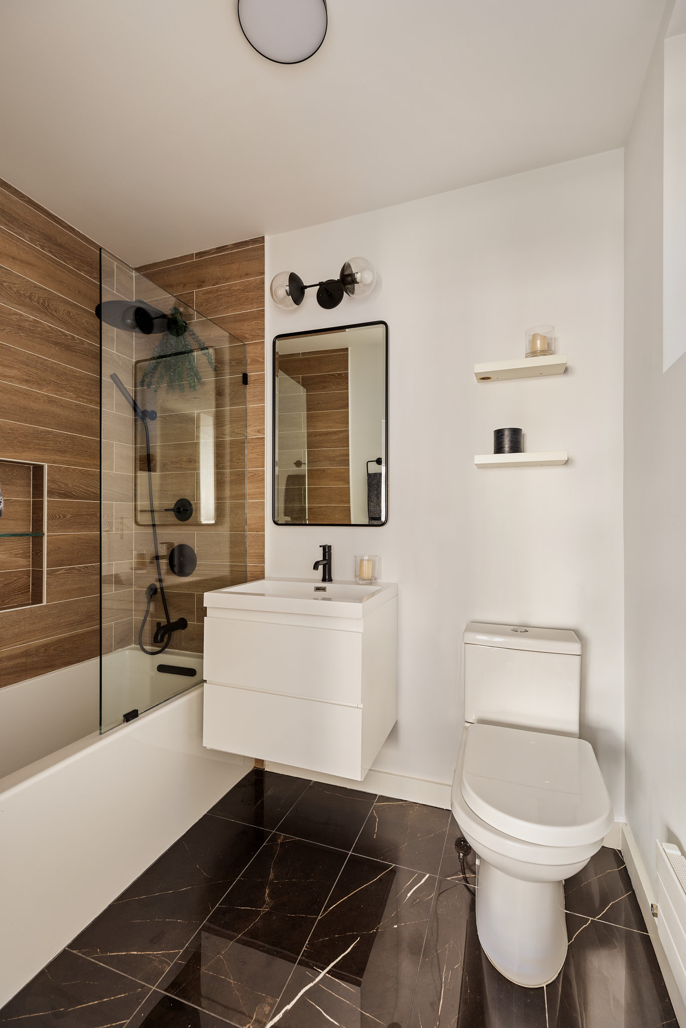 182 Mulberry Street, Unit 4 Manhattan, NY 10012 - Photo 10 of 13 a bathroom with a toilet a sink and bathtub