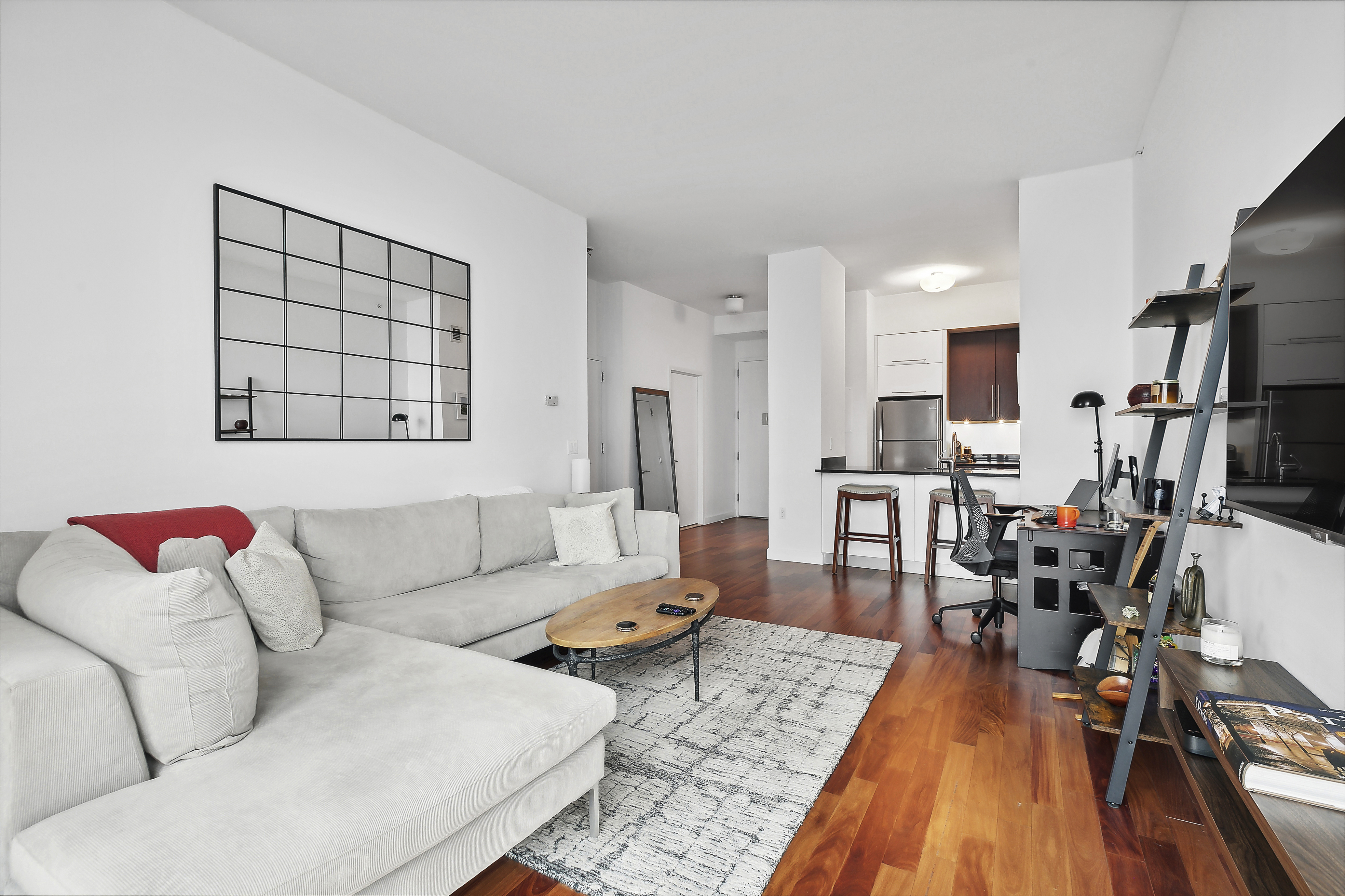 100 Jay Street, Unit 26B Brooklyn, NY 11201 - Photo 6 of 15 a living room with furniture and a wooden floor