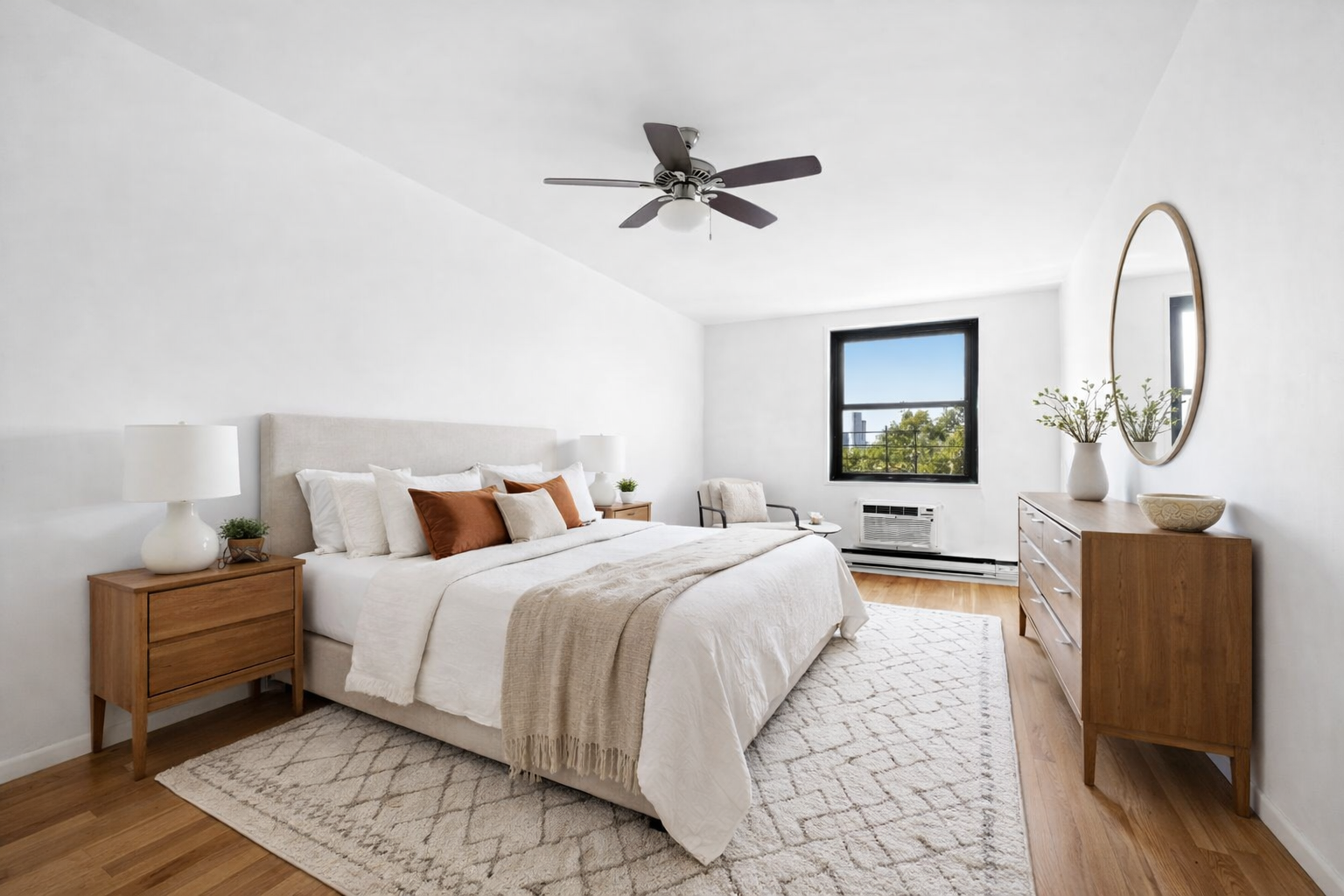 379 West Street, Unit 3B Manhattan, NY 10014 - Photo 5 of 7 a bedroom with a bed wooden floor and a mirror