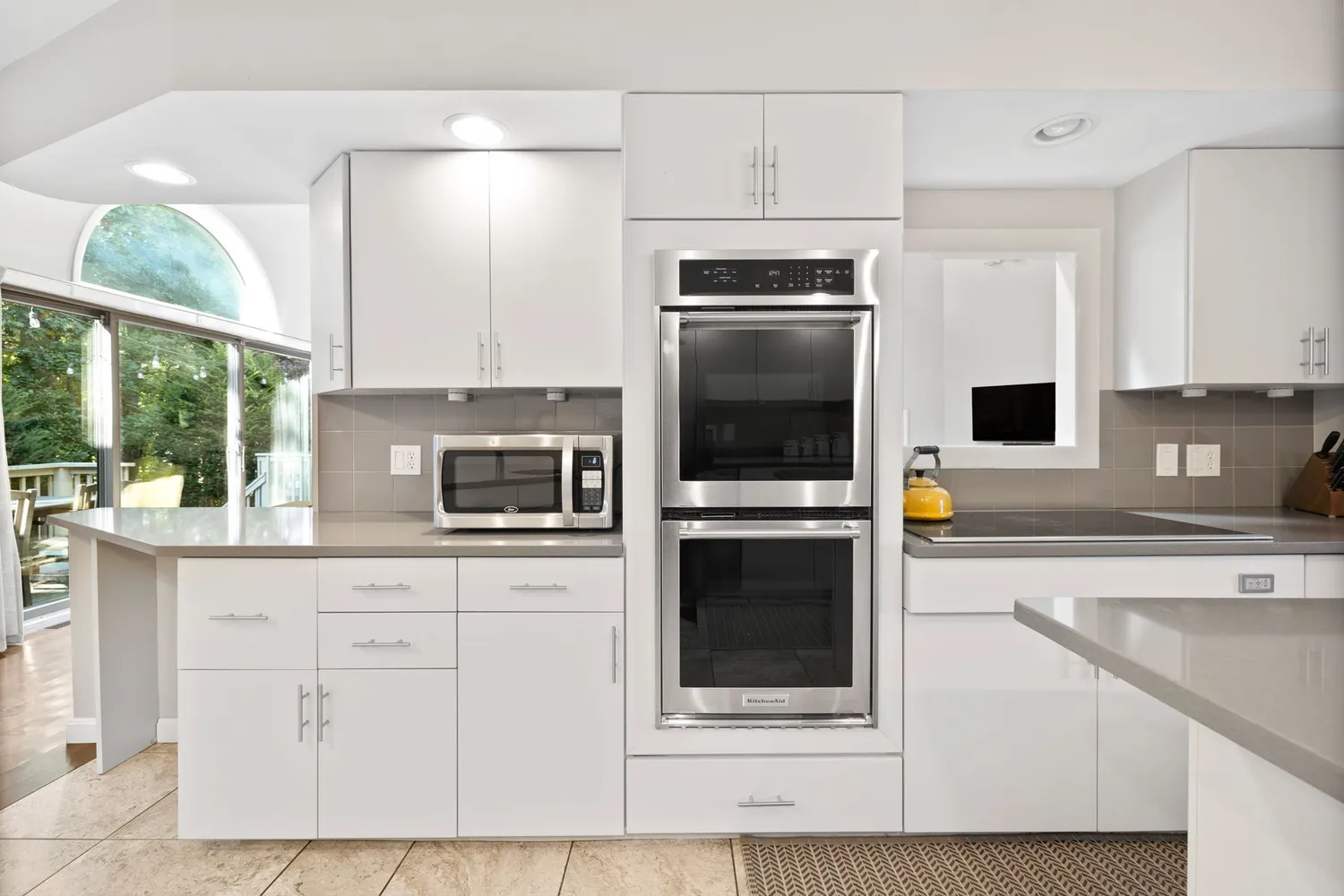 a kitchen with stainless steel appliances a stove a microwave a sink and cabinets