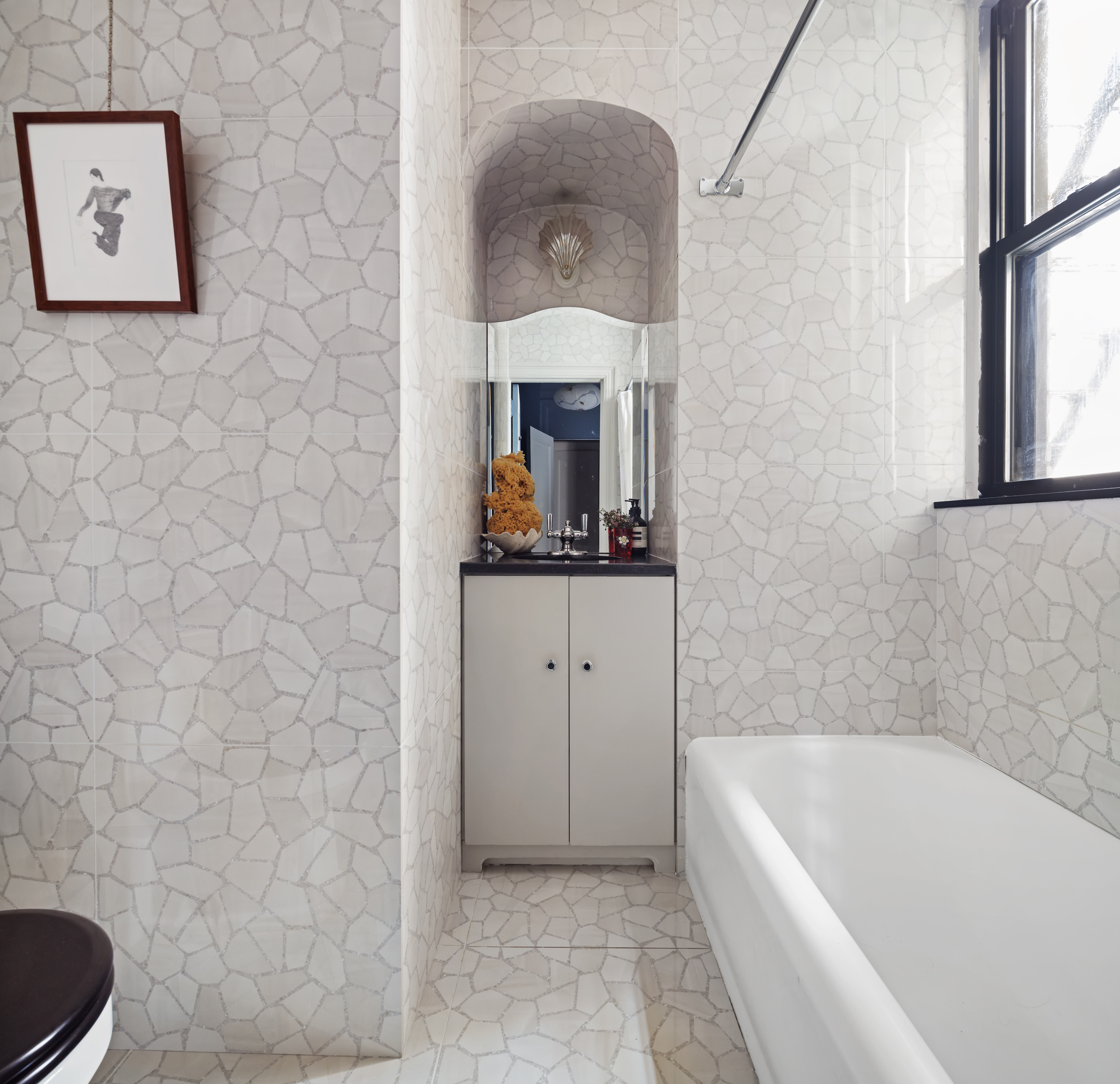 212 East 48th Street, Unit 8E Manhattan, NY 10017 - Photo 11 of 14 a bathroom with a bathtub sink and mirror